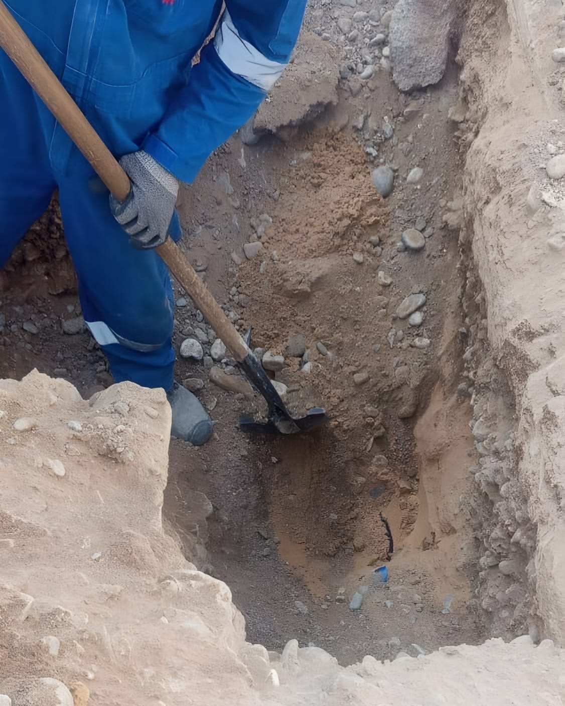 Excavating a pit by hand