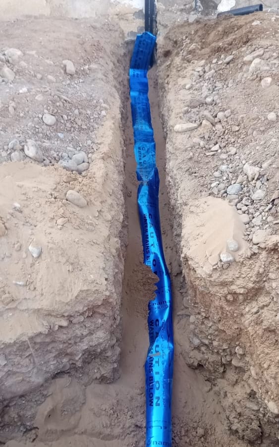 Blue warning tape laid over the new line