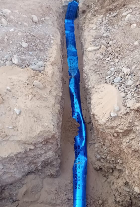 Blue warning tape laid over the new line